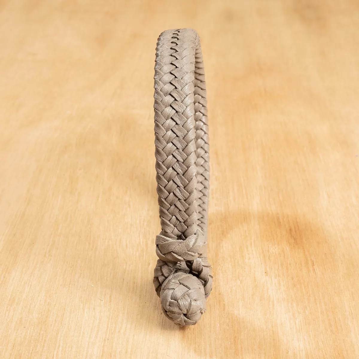 Light gray 16-strand kangaroo leather bracelet showing the braided texture and traditional knot closure