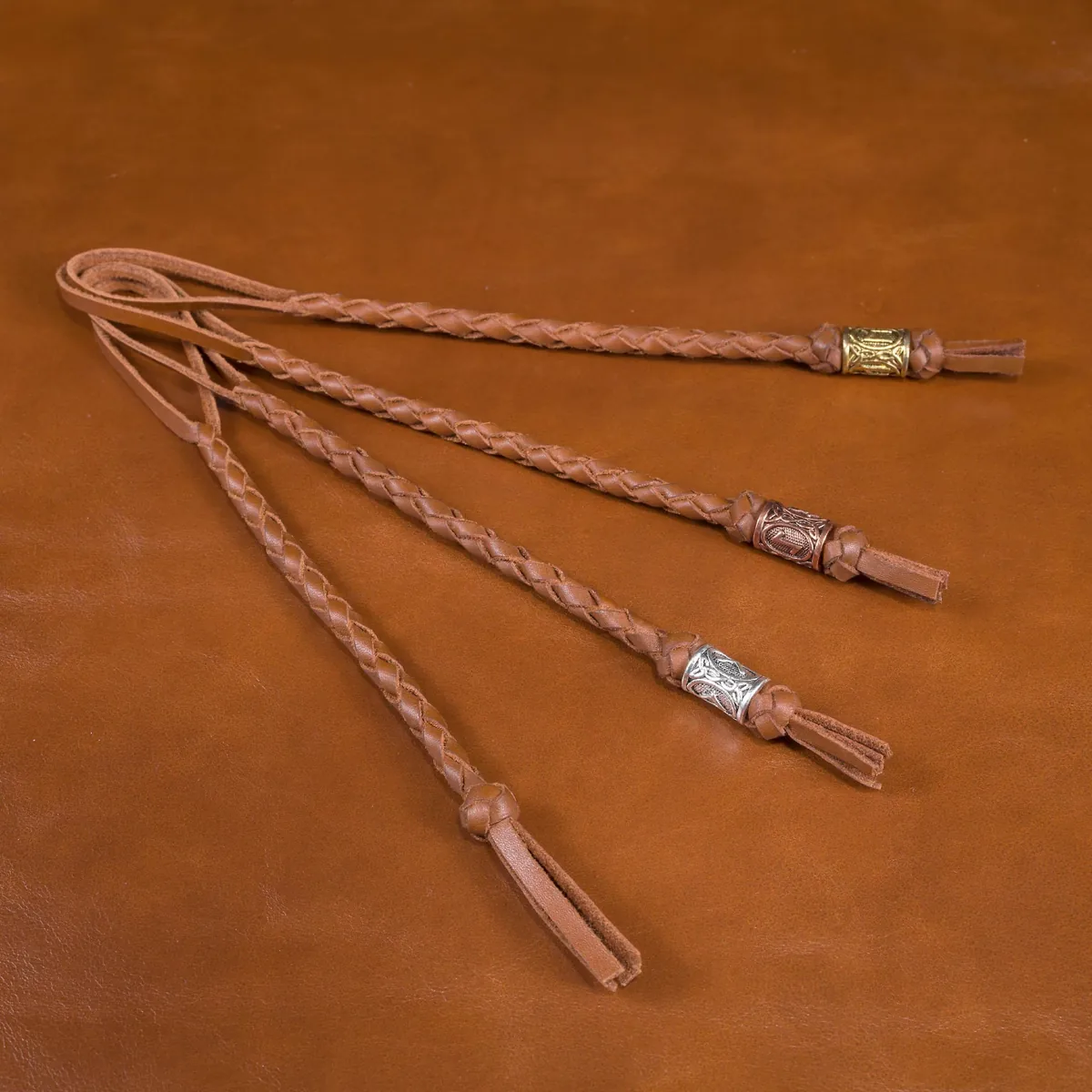 Brown hand-braided leather knife lanyards with assorted decorative bead finishes