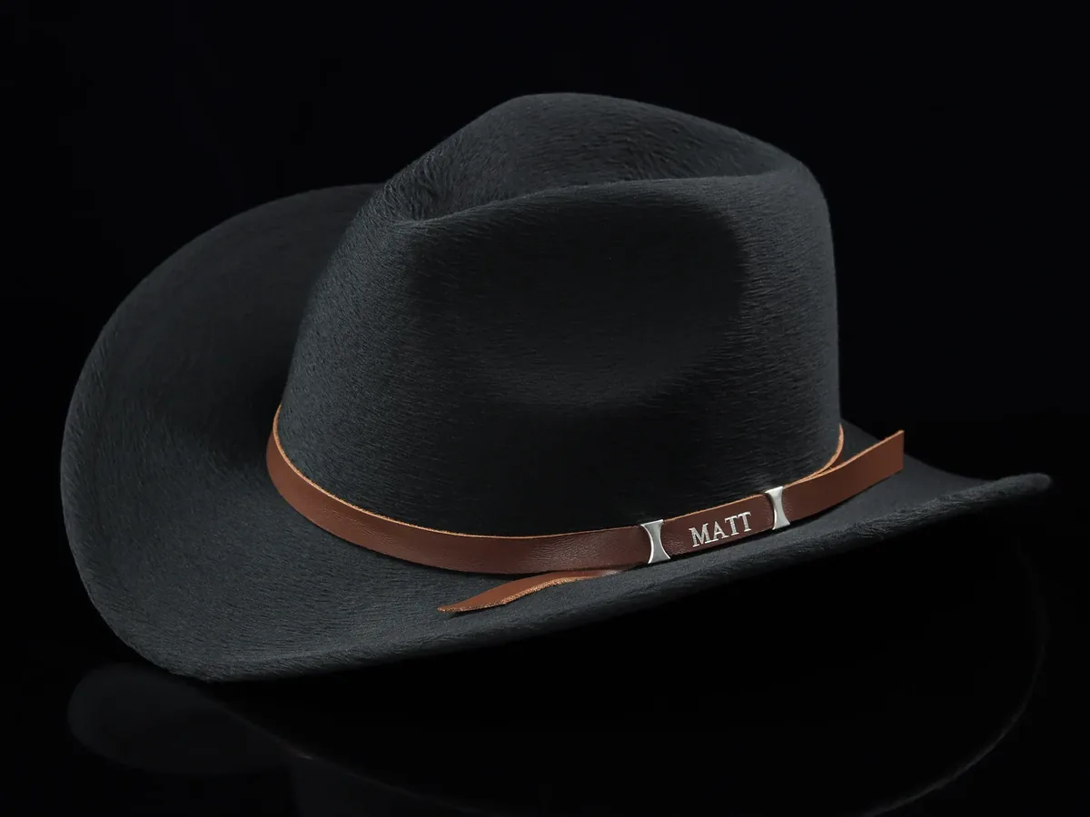 Brown personalized leather hat band with the name MATT on a black cowboy hat